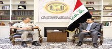 National Security Advisor Qasim Al-Araji (right), the Commander of the NATO Mission in Iraq, Major General Christoph Hentzi (left)