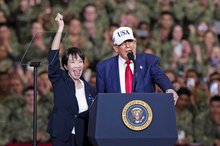 U.S. President Donald Trump (R) speaks alongside Japan's Prime Minister Sanae Takaichi (L) aboard the nuclear-powered aircraft carrier George Washington at the U.S. Yokosuka naval base near Tokyo on Oct. 28, 2025. (Kyodo)