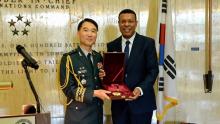 Maj. Gen. Lee Kyung-koo (L), South Korea's defense attache to the United States, presents the Taegeuk Order of Military Merit for late Gen. Douglas MacArthur to Norfolk Mayor Kenneth Alexander during a ceremony at the MacArthur Memorial in Norfolk, Virginia, on Jan. 26, 2024, in this photo provided by the defense ministry. (PHOTO NOT FOR SALE) (Yonhap)