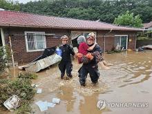 This photo, provided by fire authorities, shows rescuers evacuating a villager in Wanju on July 10, 2024. (PHOTO NOT FOR SALE) (Yonhap)