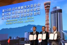 Yu In-chon (R), South Korea's minister of culture, sports and tourism, poses for a photo with Chinese Vice Minister of Culture and Tourism Zhang Zheng (L) and Japanese Minister of Land, Infrastructure, Transport and Tourism Tetsuo Saito after signing a joint statement during the trilateral tourism ministers' talks at a hotel in Kobe, Japan, on Sept. 11, 2024, in this photo provided by the South Korean ministry. (PHOTO NOT FOR SALE) (Yonhap)