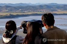 In this file photo, tourists gaze toward North Korea from an observation point at a mountain in the border city of Paju, South Korea, on Oct. 20, 2024. (Yonhap)