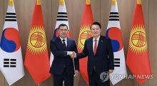 President Yoon Suk Yeol (R) and his Kyrgyz counterpart, Sadyr Japarov, pose for a photo during their summit at the presidential office in Seoul on Dec. 3, 2024. (Yonhap)