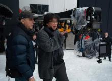 Director Bong Joon-ho (R) works on the set of his upcoming film, "Mickey 17," in this file photo provided by Warner Bros. Korea on March 14, 2024. (PHOTO NOT FOR SALE) (Yonhap)