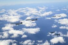 This photo, provided by the U.S. 7th Air Force, shows two U.S. B-1B bombers being escorted by two South Korean F-15K and two Japanese F-2 fighter jets, respectively, during combined drills conducted over waters near the Korean Peninsula on Jan. 15, 2025. (PHOTO NOT FOR SALE) (Yonhap)