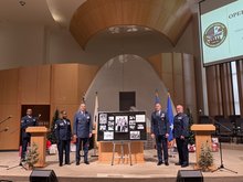 This photo shows chaplain Maj. Gen. Trent Davis (3rd from L) and other participants posing next to a plaque during an event marking the 75th anniversary of Operation Kiddy Car at Osan Air Base in Pyeongtaek, some 65 kilometers south of Seoul, on Dec. 17, 2025. (Yonhap)