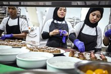  Staff prepare dessert dishes in the kitchen of the Kuala Lumpur Convention Centre for events held in conjunction with the 46th ASEAN Summit.
