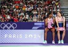 Malaysian badminton women's doubles pair Pearly Tan and M. Thinaah share a light moment during their Paris 2024 Olympics semi-finals at Porte de La Chapelle Arena on Friday