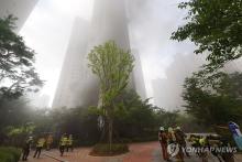 Smoke covers an apartment complex after a fire suspected to have started from an electric vehicle in the underground parking lot occurred in Incheon, west of Seoul, on Aug. 1, 2024. (Yonhap)