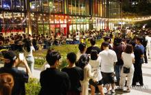 People are seen lining up to enter a night market in the southeastern city of Busan despite the heat wave and tropical nights continuing to bake the region on Aug. 11, 2024. (Yonhap)