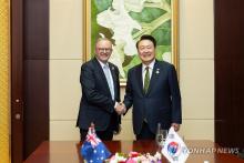 President Yoon Suk Yeol (R) and Australian Prime Minister Anthony Albanese shake hands during their meeting at the National Convention Center in Vientiane, Laos, on Oct. 11, 2024, on the sidelines of the East Asia Summit. (Pool photo) (Yonhap)