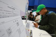 A participant fills out a resume at a senior job fair held in Hanam, east of Seoul, on June 11, 2025. (Yonhap)