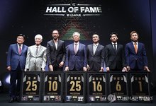 Inductees of the 2025 class for the Korean Professional Football League (K League) Hall of Fame pose for photos next to K League Commissioner Kwon Oh-gap (L) after their induction ceremony at the Asan Institute for Policy Studies in Seoul on Sept. 16, 2025. From 2nd to left: Kim Ho, Dejan Damjanovic, Chung Mong-joon, Kim Joo-sung, Yoo Sun-woo, son of the late inductee Yoo Sang-chul, and Kim Byung-ji. (Yonhap)