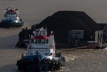 A coal-shipping barge sails in Musi River, Palembang, South Sumatra, on Friday (Jan 14, 2022). ANTARA PHOTO/Nova Wahyudi/rwa.