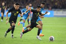 Malaysian players, Mohamad Faisal Abdul Halim and Arif Aiman Mohd Hanapi, in the opening match of the 2023 Merdeka Football Festival, where Malaysia faced India at the Bukit Jalil National Stadium, Friday.