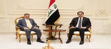 First Deputy Speaker of the Iraqi Parliament, Mohsen Al-Mandalawi, (right), the Chargé d'Affaires of the U.S. Embassy in Iraq, Steven Fagin (left)  