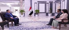 PM, Mohammed Shia Al-Sudani (left), AP's journalists (right) 