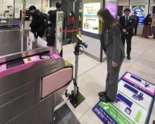 An official demonstrates facial recognition using a tablet device at a ticket gate in Keisei-Ueno Station in Tokyo on Jan. 23, 2025. (Kyodo)