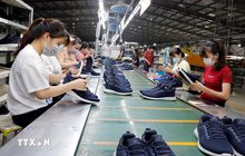 Workers produce footwear for export. (Photo: VNA)