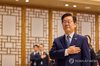 President Lee Jae Myung salutes the national flag during his meeting with families of fallen officers held at the presidential office in Seoul's Yongsan district on Dec. 26, 2025, in this photo provided by Lee's office. (PHOTO NOT FOR SALE) (Yonhap)