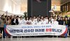South Korean athletes and officials competing at the 2026 Winter Olympics pose behind a banner from the South Korean community in Milan, welcoming them to the host city of the competition, at Milan Malpensa Airport in Milan, Italy, on Jan. 31, 2026, in this photo provided by the Korean Sport & Olympic Committee. (PHOTO NOT FOR SALE) (Yonhap)