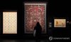 Visitors look at Islamic carpets on display at the exhibition "Islamic Art: A Journey of Splendor" at the National Museum of Korea in central Seoul on Nov. 21, 2025. (Yonhap)